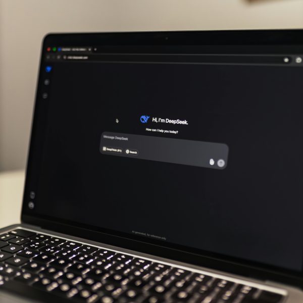 Close-up view of an AI chat interface on a laptop screen in a dimly lit room.