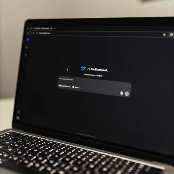 Close-up view of an AI chat interface on a laptop screen in a dimly lit room.