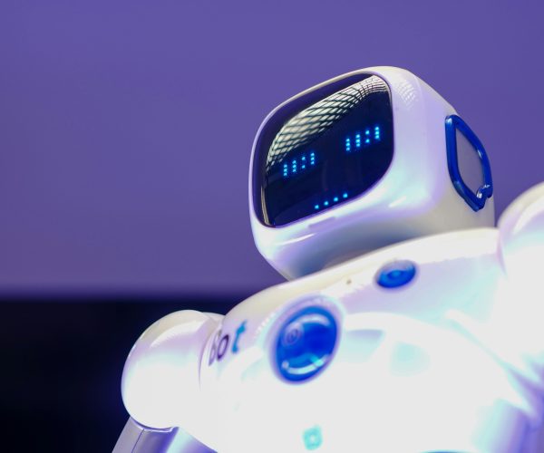 A modern humanoid robot with digital face and luminescent screen, symbolizing innovation in technology.