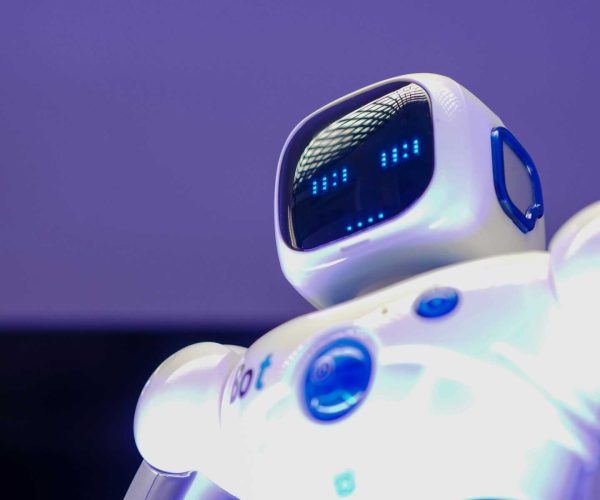A modern humanoid robot with digital face and luminescent screen, symbolizing innovation in technology.